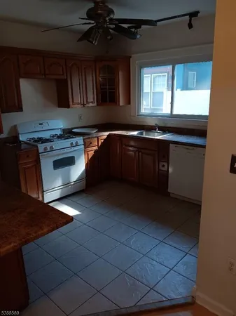 a kitchen with granite countertop a stove and a sink