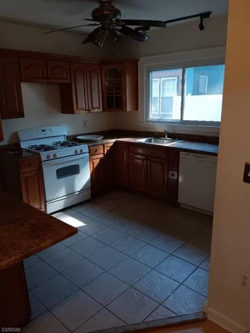 a kitchen with granite countertop a stove and a sink
