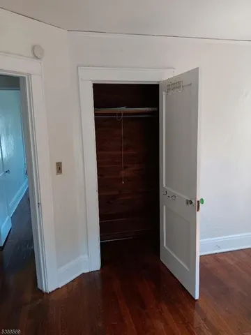 a view of walk in closet with wooden floor