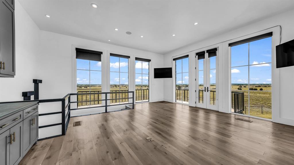 11802 East Rocky Creek Road Crowley, TX 76036 - Photo 26 of 40 a view of empty room with wooden floor and windows