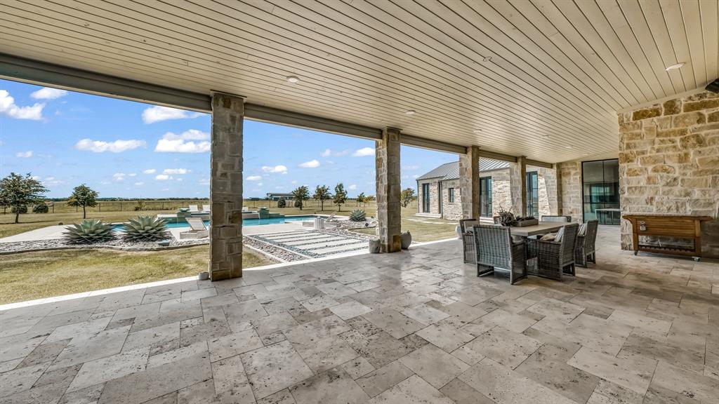 11802 East Rocky Creek Road Crowley, TX 76036 - Photo 28 of 40 a view of a patio with a table under an umbrella