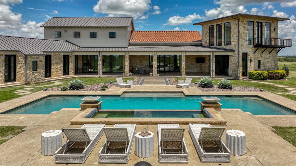 11802 East Rocky Creek Road Crowley, TX 76036 - Photo 30 of 40 a view of a house with pool lawn chairs and a barbeque