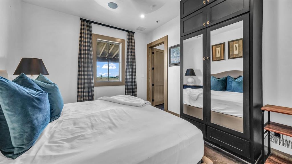 11802 East Rocky Creek Road Crowley, TX 76036 - Photo 35 of 40 a bedroom with a large bed and a chandelier