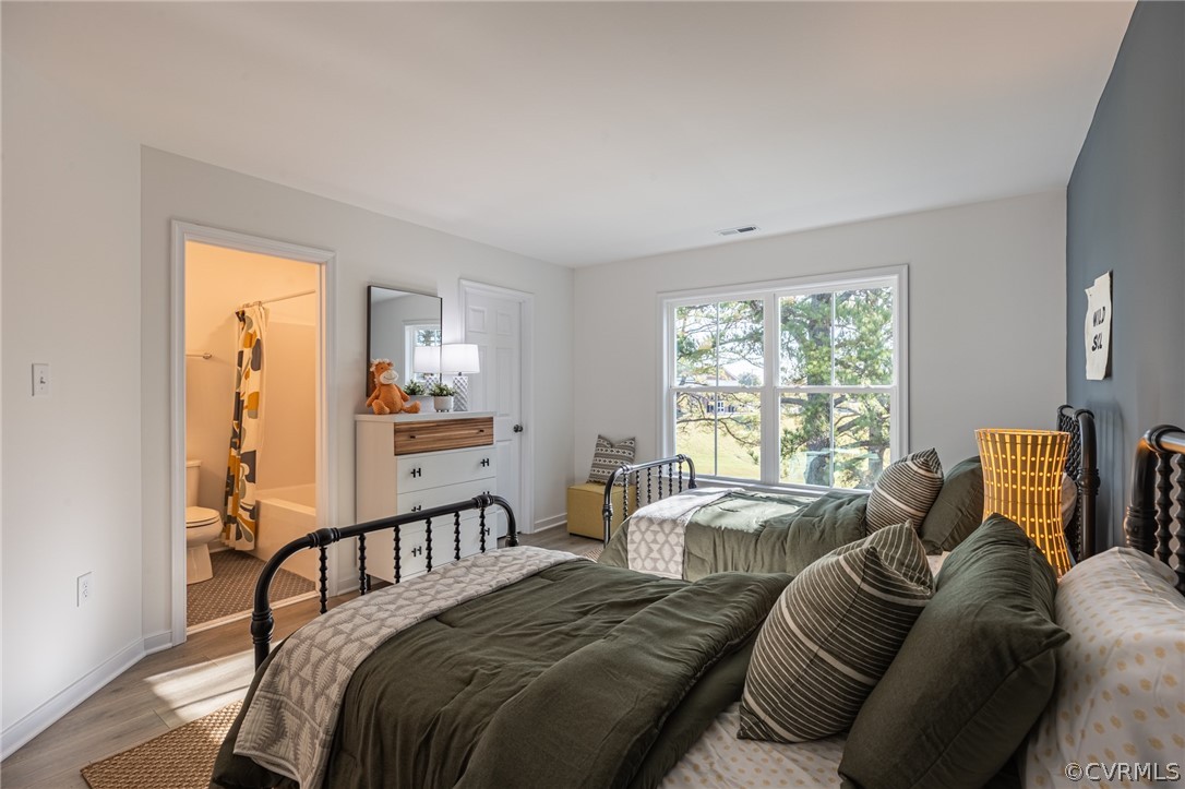 1602 Reed Marsh Place Goochland, VA 23063 - Photo 26 of 41 a bedroom with a bed and glass windows