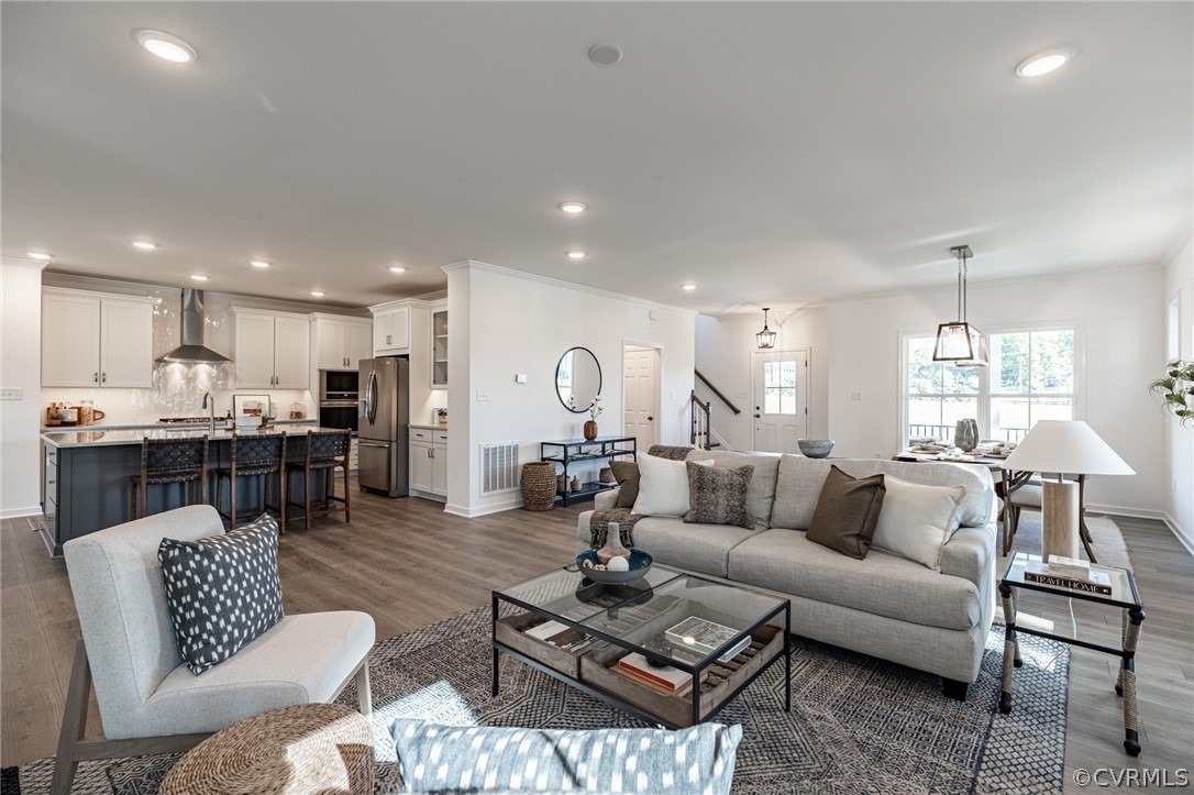 1602 Reed Marsh Place Goochland, VA 23063 - Photo 6 of 41 a living room with furniture kitchen view and a wooden floor