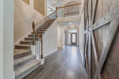 a view of staircase with white walls and a window