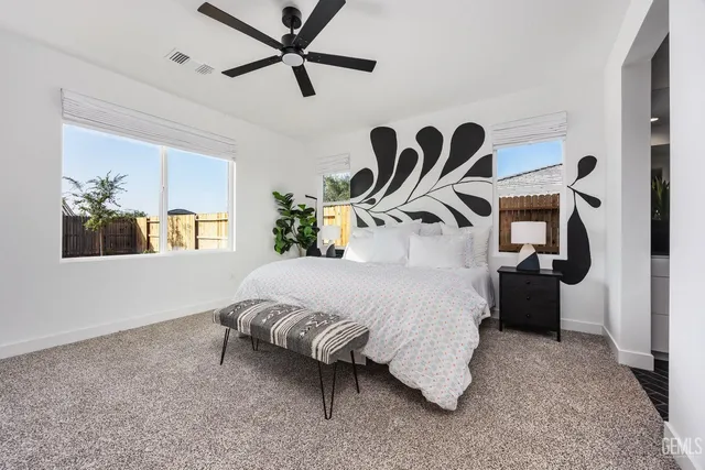 a bed room with a bed and a painting on the wall