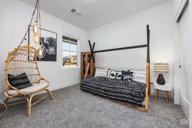 a living room with furniture a rug and white walls