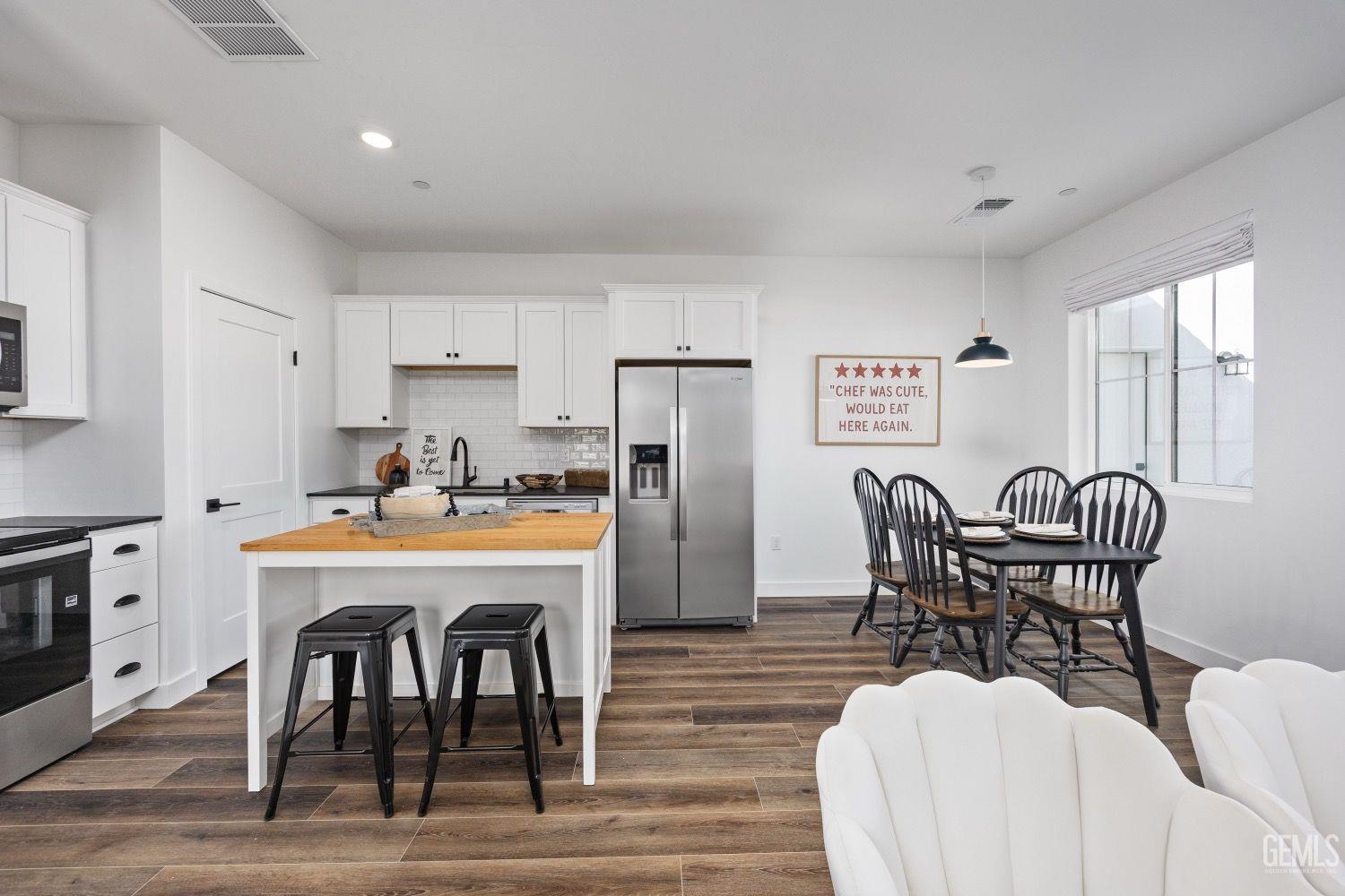 Undisclosed Address Bakersfield, CA 93314 - Photo 22 of 26 a view of a dining room with furniture and wooden floor