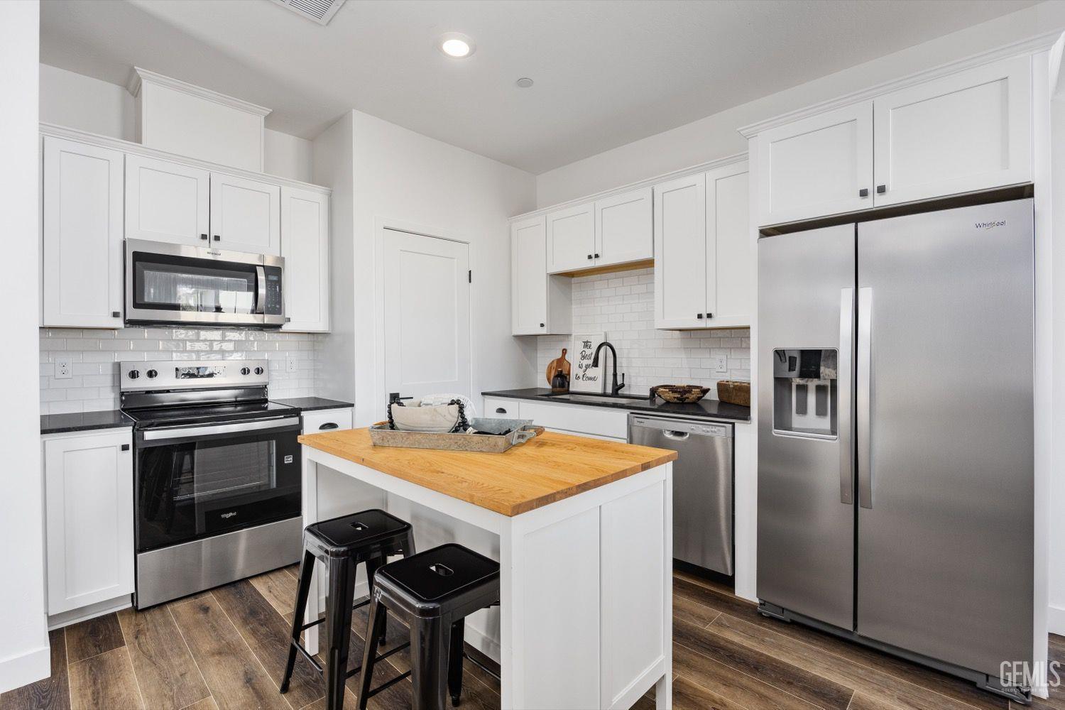 Undisclosed Address Bakersfield, CA 93314 - Photo 25 of 26 a kitchen with stainless steel appliances a stove a sink a refrigerator a microwave and cabinets