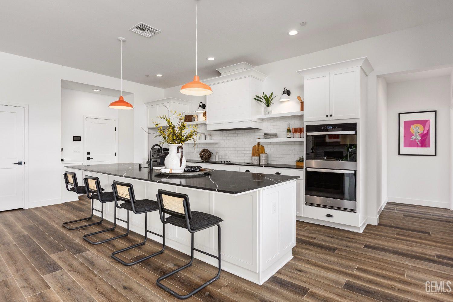 Undisclosed Address Bakersfield, CA 93314 - Photo 7 of 26 a kitchen with stainless steel appliances kitchen island granite countertop a sink and cabinets