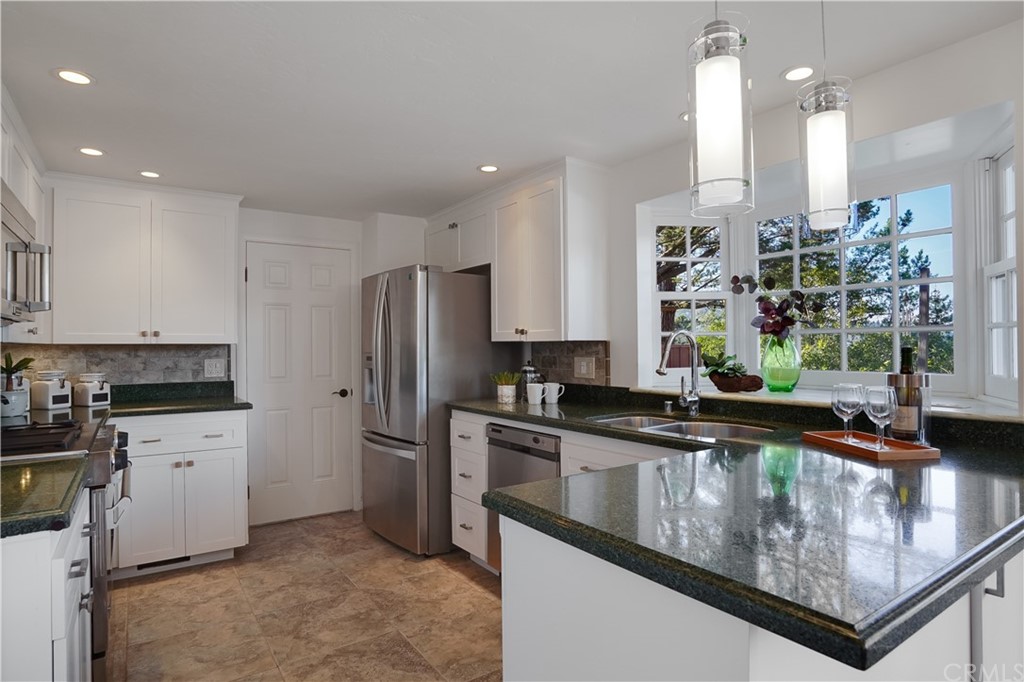 1988 Timberlane Way San Mateo, CA 94402 - Photo 29 of 36 a kitchen with stainless steel appliances granite countertop a sink a stove and a refrigerator