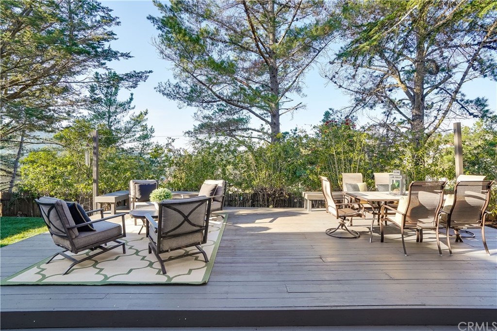 1988 Timberlane Way San Mateo, CA 94402 - Photo 36 of 36 a view of a patio with table and chairs and potted plants with wooden floor and fence