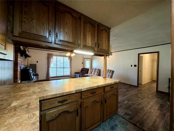 a dining room with furniture a chandelier and wooden floor