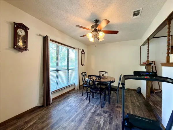a bedroom with a bed and a ceiling fan