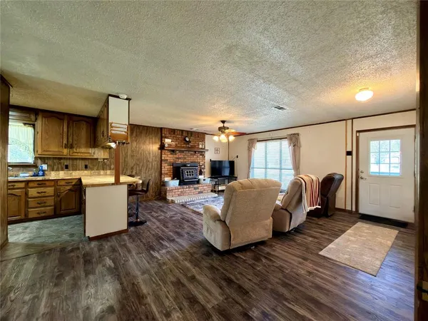 a living room with furniture a dining table and a fireplace