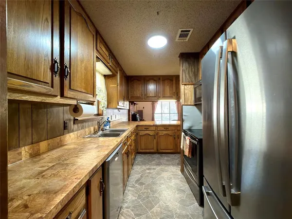 a kitchen with a sink and cabinets