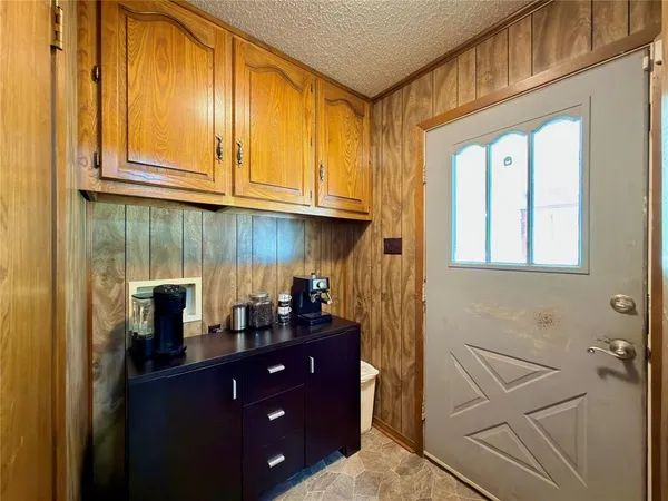 a kitchen with kitchen island granite countertop wooden cabinets a sink and dishwasher