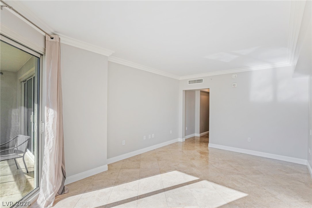 2777 Paradise Road, Unit 901 Las Vegas, NV 89109 - Photo 11 of 27 Empty room featuring baseboards, visible vents, and crown molding