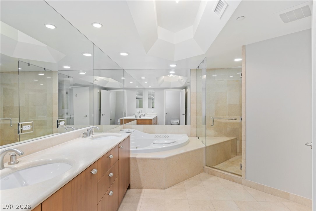2777 Paradise Road, Unit 901 Las Vegas, NV 89109 - Photo 13 of 27 Bathroom featuring a sink, a shower stall, a garden tub, and visible vents