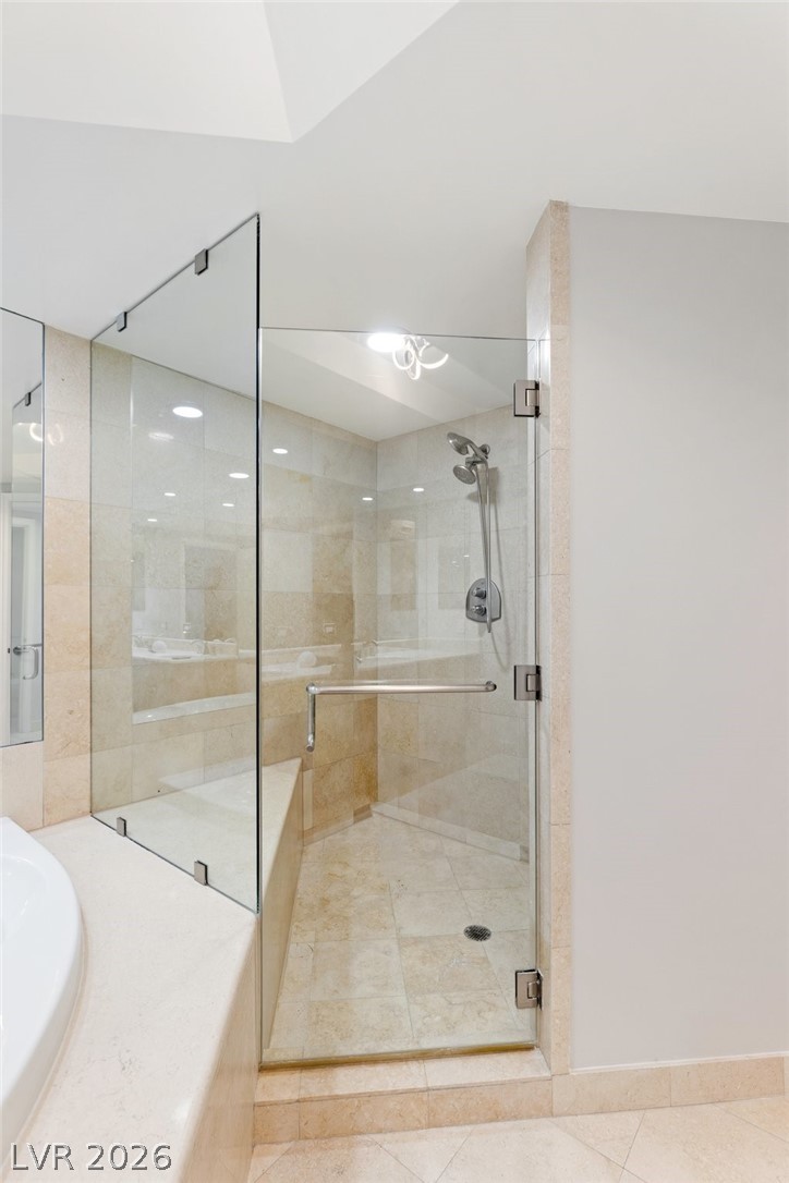 2777 Paradise Road, Unit 901 Las Vegas, NV 89109 - Photo 15 of 27 Full bathroom with a shower stall, tile patterned floors, a sink, and a garden tub