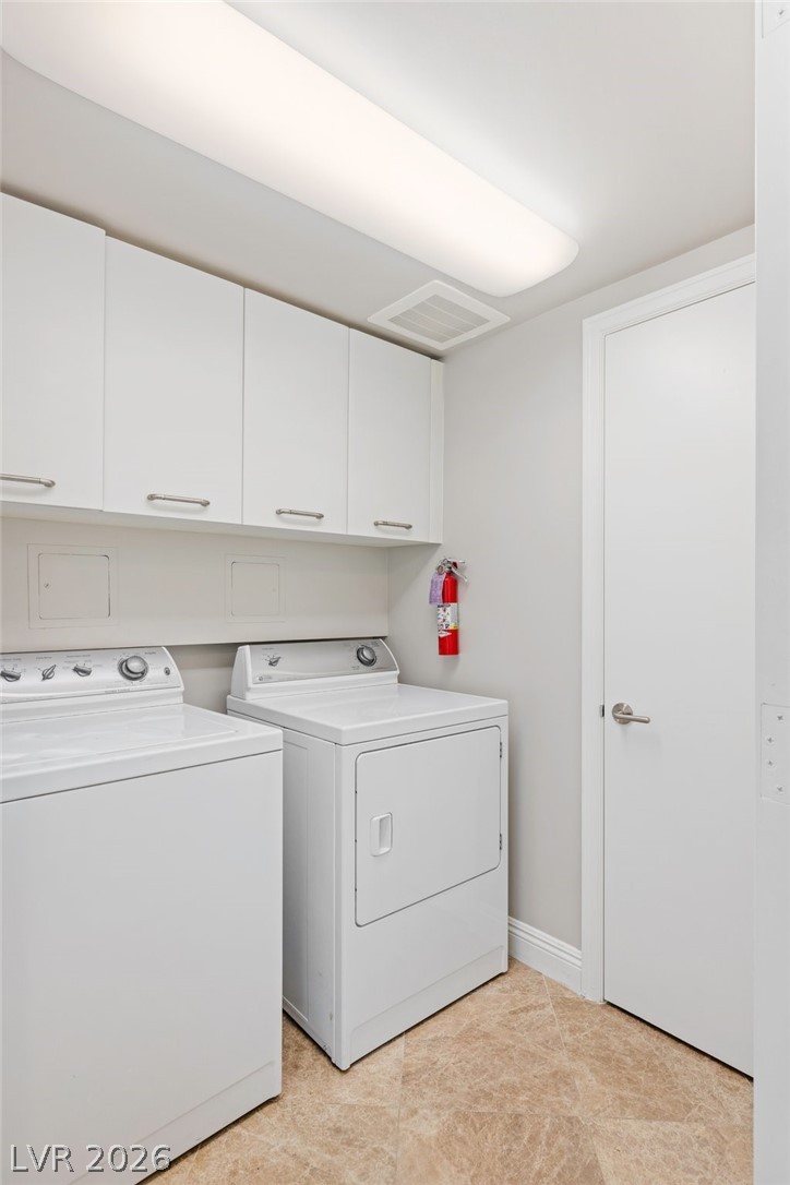 2777 Paradise Road, Unit 901 Las Vegas, NV 89109 - Photo 16 of 27 Laundry room with washer and clothes dryer, cabinet space, baseboards, and visible vents