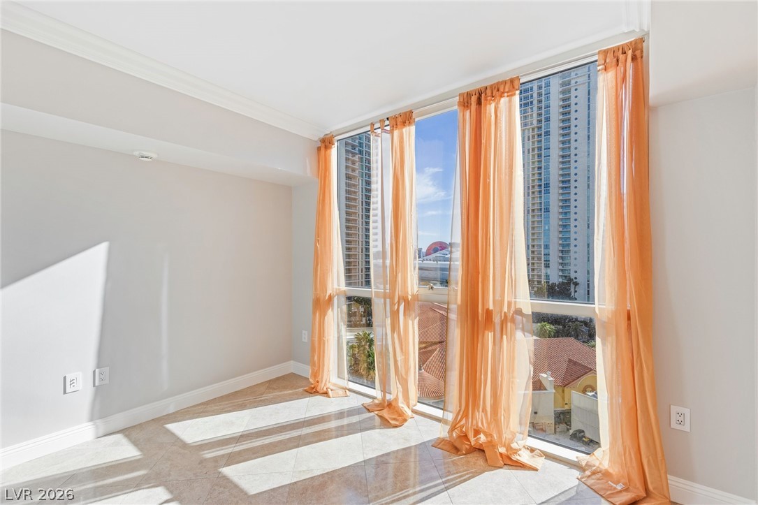 2777 Paradise Road, Unit 901 Las Vegas, NV 89109 - Photo 20 of 27 Unfurnished room with baseboards, ornamental molding, and a wall of windows