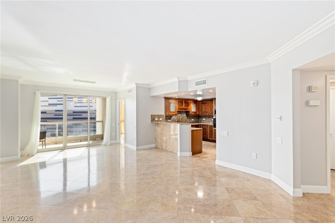 2777 Paradise Road, Unit 901 Las Vegas, NV 89109 - Photo 2 of 27 Unfurnished living room with baseboards, visible vents, and crown molding