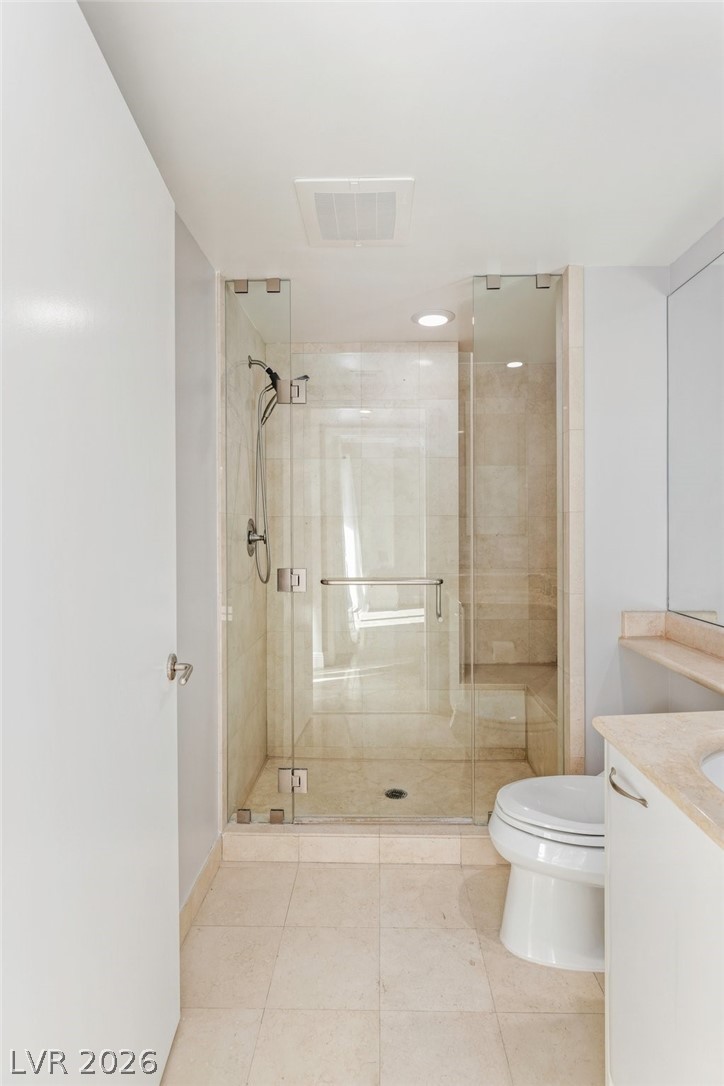 2777 Paradise Road, Unit 901 Las Vegas, NV 89109 - Photo 23 of 27 Full bathroom featuring a stall shower, tile patterned floors, toilet, vanity, and visible vents