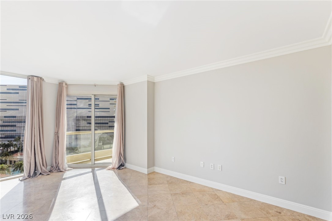 2777 Paradise Road, Unit 901 Las Vegas, NV 89109 - Photo 10 of 27 Spare room with baseboards, ornamental molding, and light tile patterned floors