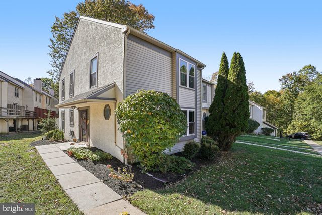 a view of a brick house with a yard