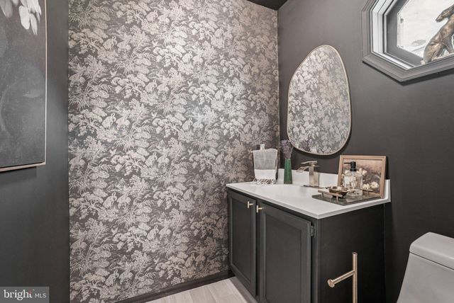 a spacious bedroom with a bed couch and window