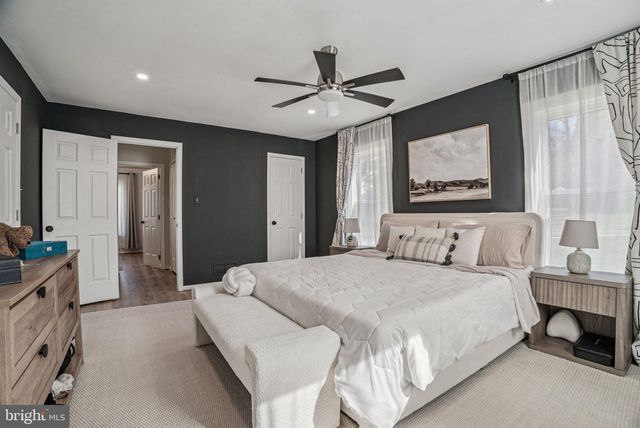 a bathroom with a granite countertop toilet sink and mirror