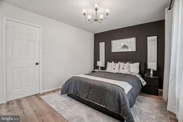a bathroom with a toilet a sink a vanity and mirror