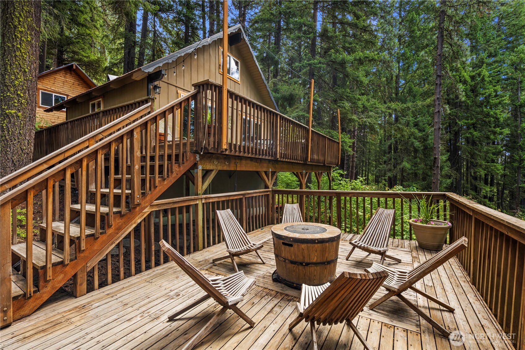 61 Hideaway Lane Ronald, WA 98940 - Photo 22 of 30 a view of a roof deck with table and chairs with wooden floor and fence