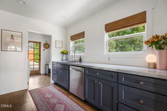 a spacious bathroom with a granite countertop sink and a window