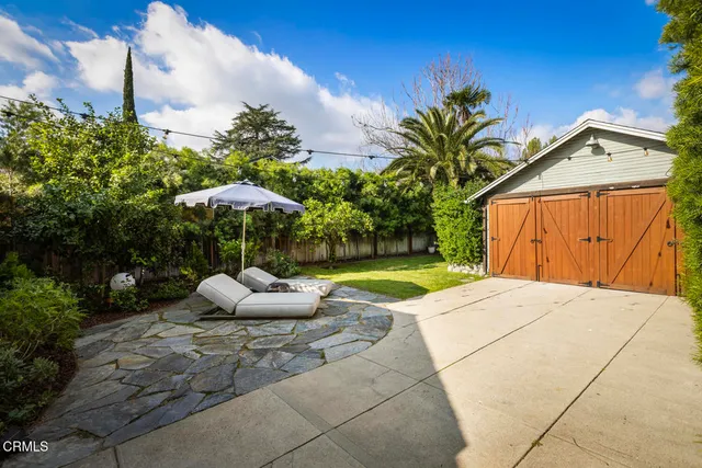 a view of a backyard with plants and a garden