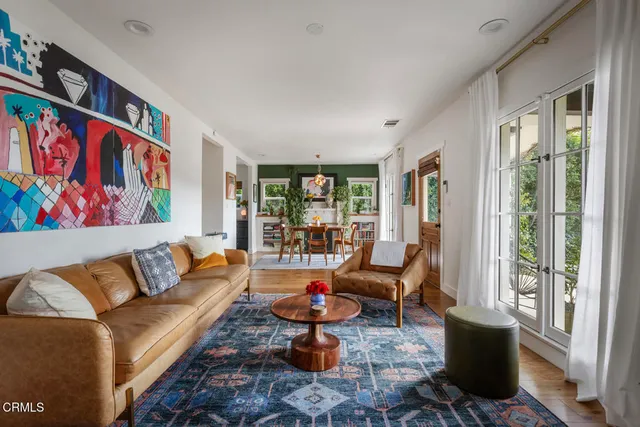 a living room with furniture and a floor to ceiling window