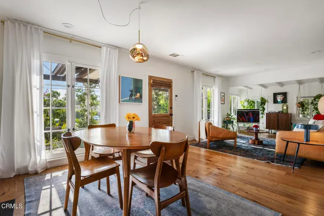 a view of a dining room with furniture window and wooden floor