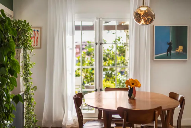 a view of a dining room with furniture window and wooden floor