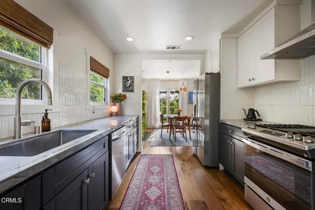 a kitchen with stainless steel appliances granite countertop a lot of counter space and a sink