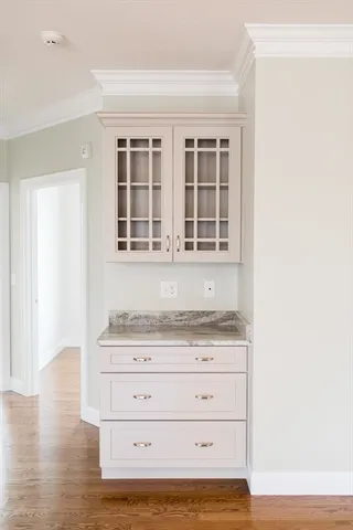 a view of wooden floor and cabinets in a room