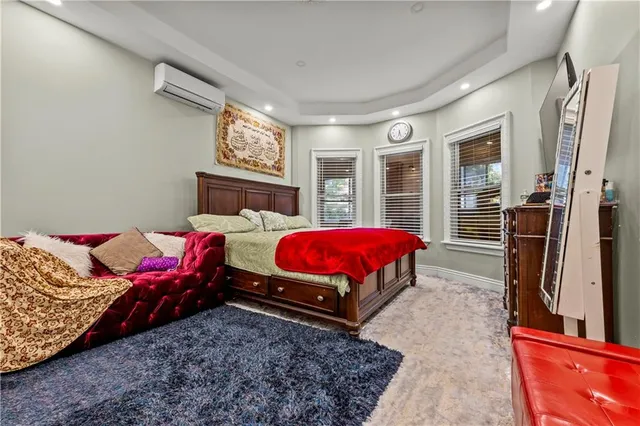 a bed room with a bed window and a flat screen tv