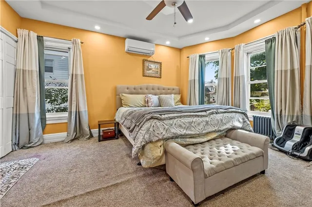 a bedroom with a bed couch and window