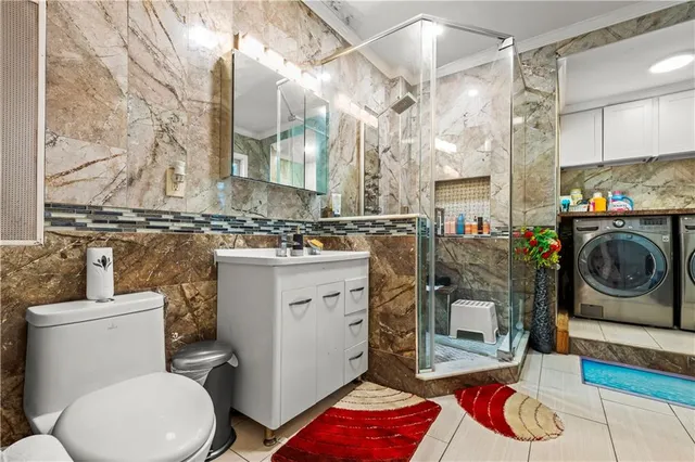 a bathroom with a toilet a sink and a mirror