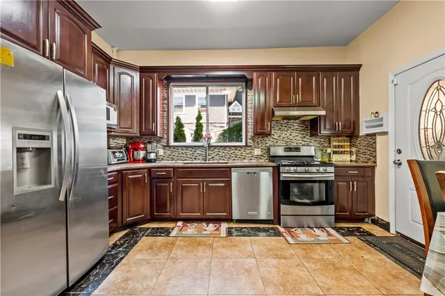 a kitchen with stainless steel appliances a refrigerator stove and sink