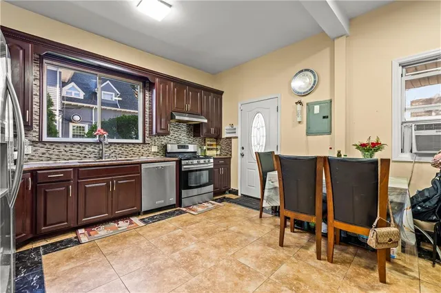 a open kitchen with a sink dining table and chairs