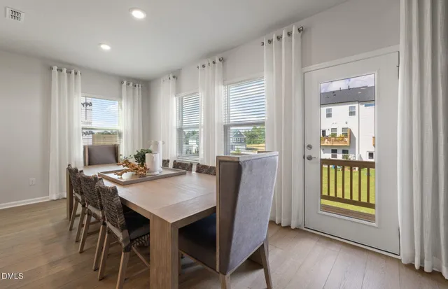 a kitchen with stainless steel appliances a sink a refrigerator and cabinets