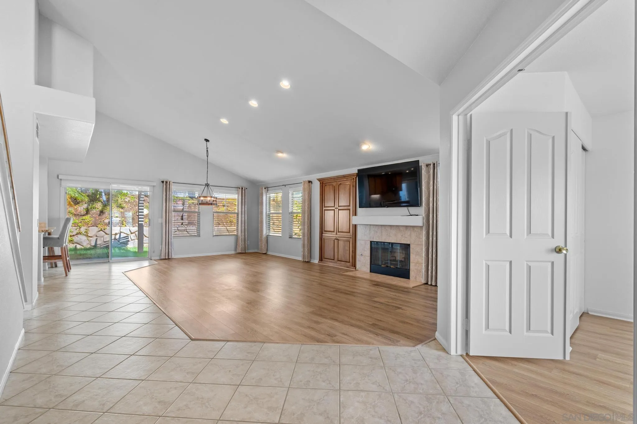 2028 Boulders Road Alpine, CA 91901 - Photo 14 of 56 a view of a hallway with wooden floor and a fireplace
