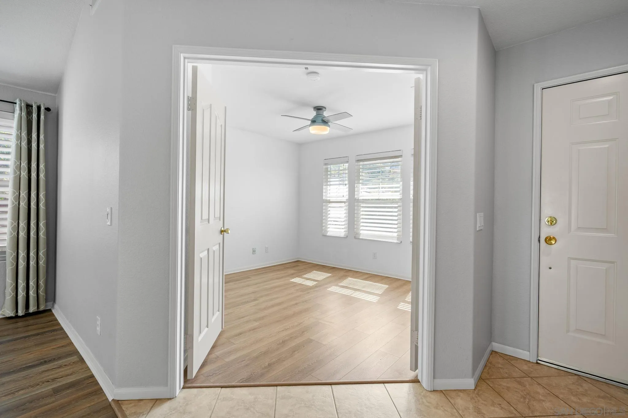 2028 Boulders Road Alpine, CA 91901 - Photo 15 of 56 a view of an empty room with wooden floor and a window